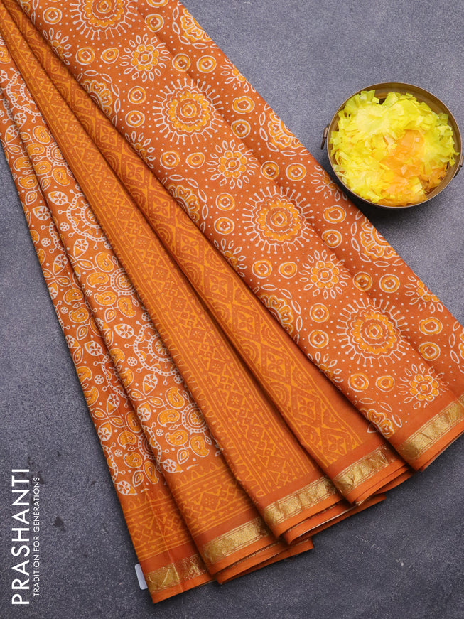 Muslin cotton saree orange with allover ajrakh prints and small zari woven border