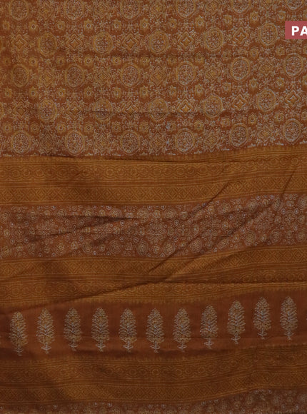 Muslin cotton saree dark mustard with allover ajrakh prints and thread woven border