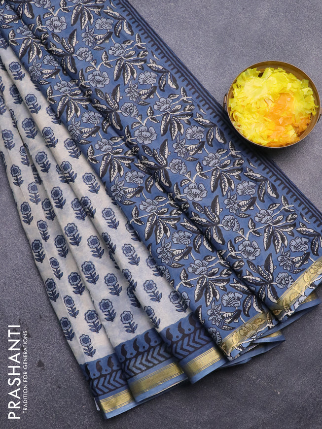 Muslin cotton saree off white and blue with floral butta prints and zari woven border