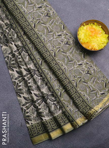 Muslin cotton saree cream and green with allover floral prints and small zari woven border