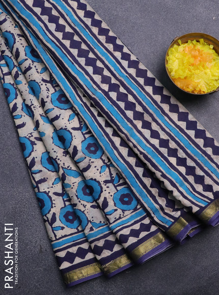 Muslin cotton saree cream and blue with allover prints and small zari woven border