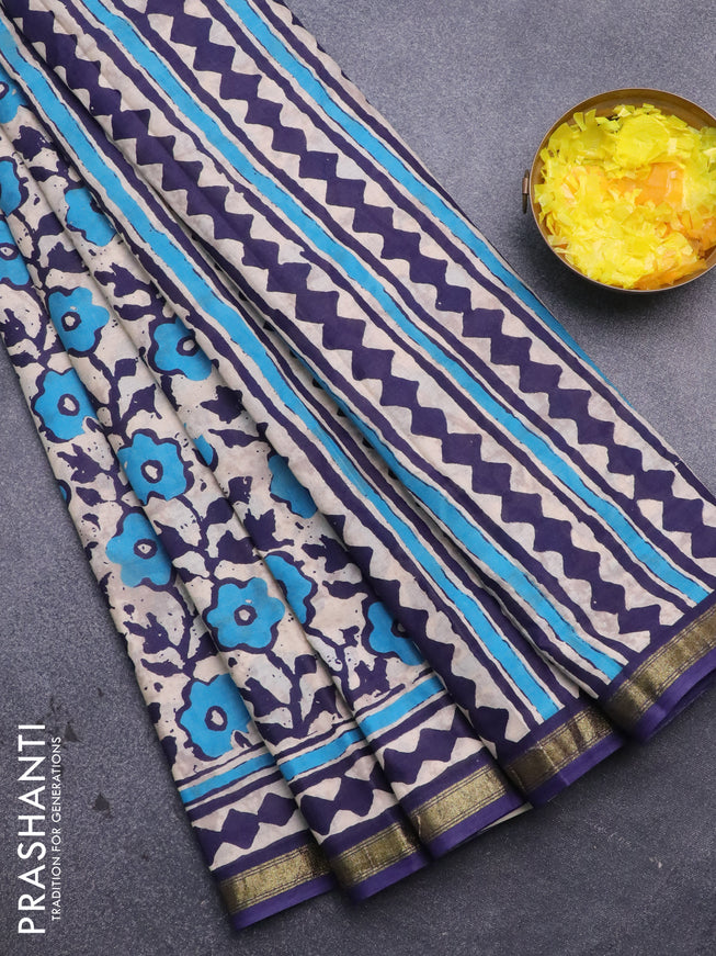 Muslin cotton saree cream and blue with allover prints and small zari woven border