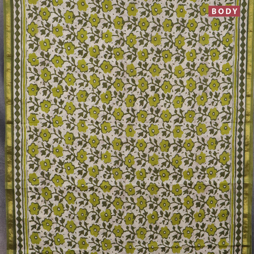 Muslin cotton saree cream and sap green with allover prints and small zari woven border