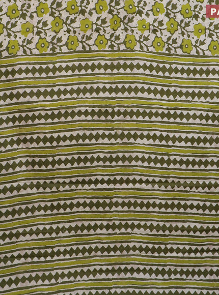 Muslin cotton saree cream and sap green with allover prints and small zari woven border