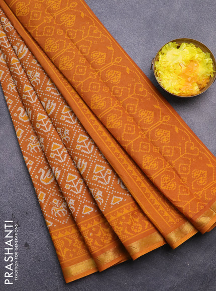 Muslin cotton saree mustard yellow with allover patola prints and small zari woven border