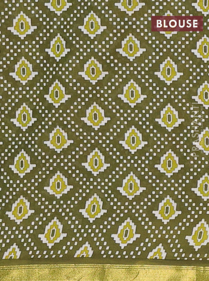 Muslin cotton saree sap green with allover patola prints and small zari woven border