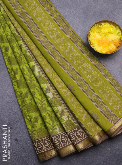 Muslin cotton saree light green and brown with allover prints and small zari woven border