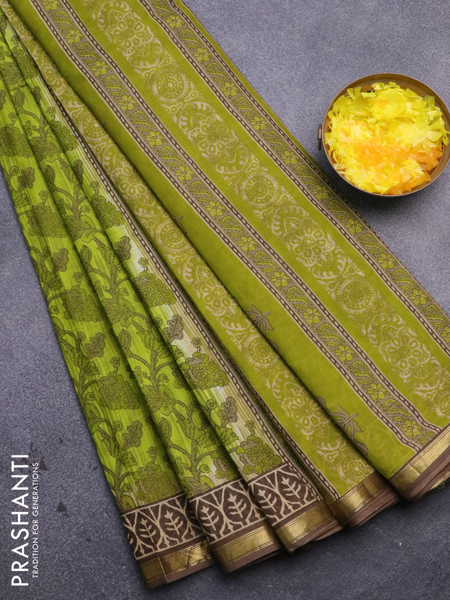 Muslin cotton saree light green and brown with allover prints and small zari woven border