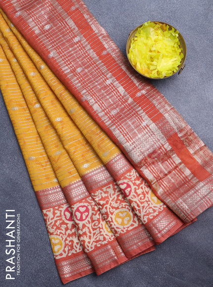 Assam silk saree mustard yellow and rust shade with allover zari weaves and rettapet zari woven batik printed border