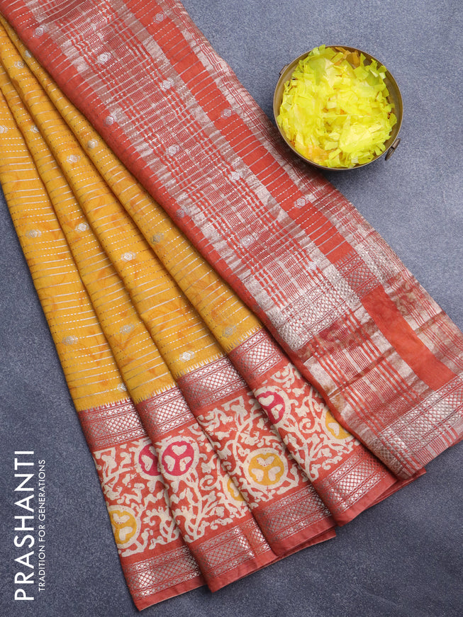 Assam silk saree mustard yellow and rust shade with allover zari weaves and rettapet zari woven batik printed border