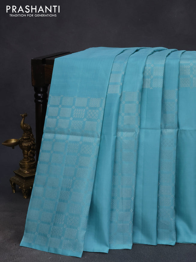 Pure soft silk saree teal blue shade with silver zari woven geometric buttas in borderless style