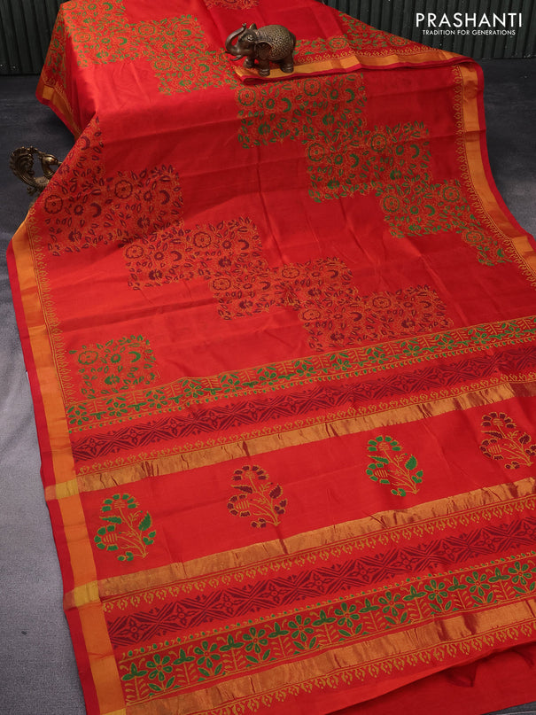 Silk cotton block printed saree reddish orange with allover prints and zari woven border