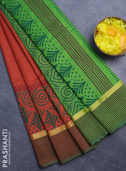 Silk cotton block printed saree rust shade and light green with prints and zari woven printed border