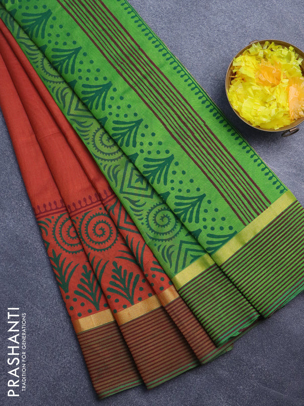 Silk cotton block printed saree rust shade and light green with prints and zari woven printed border