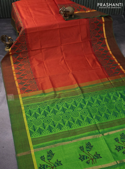 Silk cotton block printed saree rust shade and light green with prints and zari woven printed border