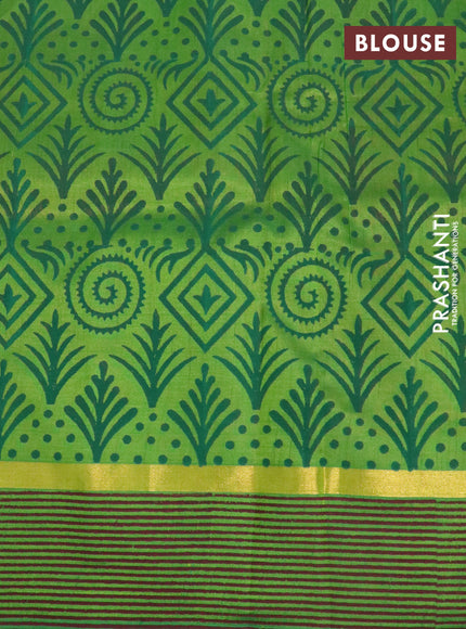 Silk cotton block printed saree rust shade and light green with prints and zari woven printed border