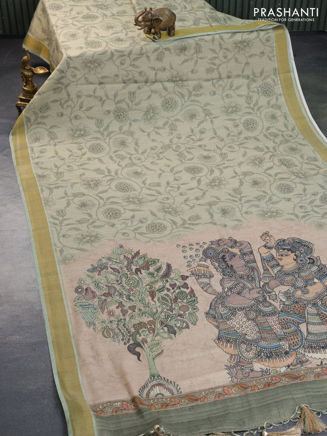 Tissue silk saree pastel green with allover kalamkari prints and zari woven border