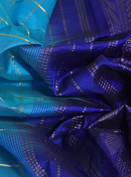 Silk cotton saree teal blue and blue with allover zari checked pattern and rettapet zari woven border