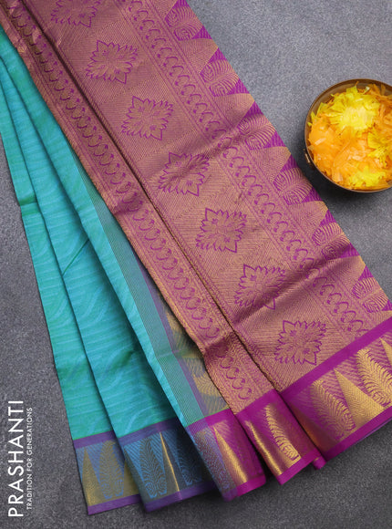 Silk cotton saree dual shade of teal bluish green and purple with allover self emboss & jacquard and zari woven border