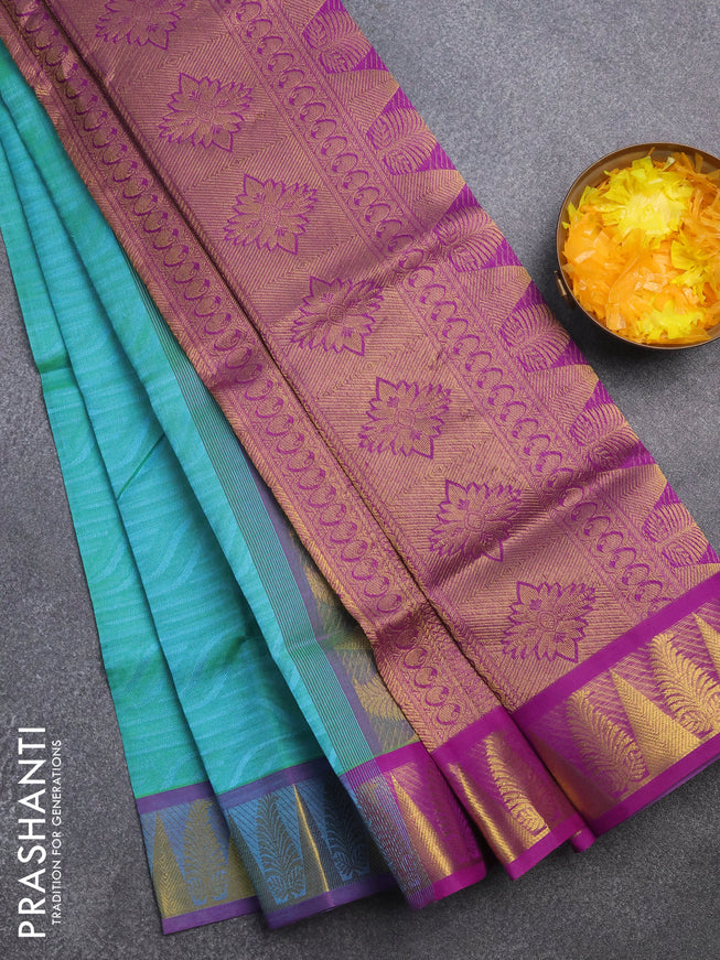 Silk cotton saree dual shade of teal bluish green and purple with allover self emboss & jacquard and zari woven border