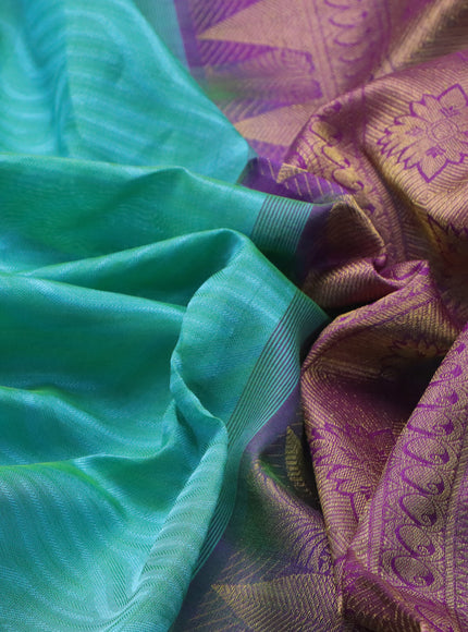 Silk cotton saree dual shade of teal bluish green and purple with allover self emboss & jacquard and zari woven border