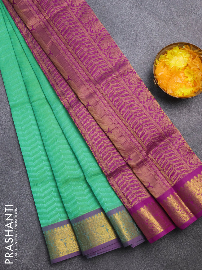 Silk cotton saree green and purple with allover self emboss & jacquard and zari woven border