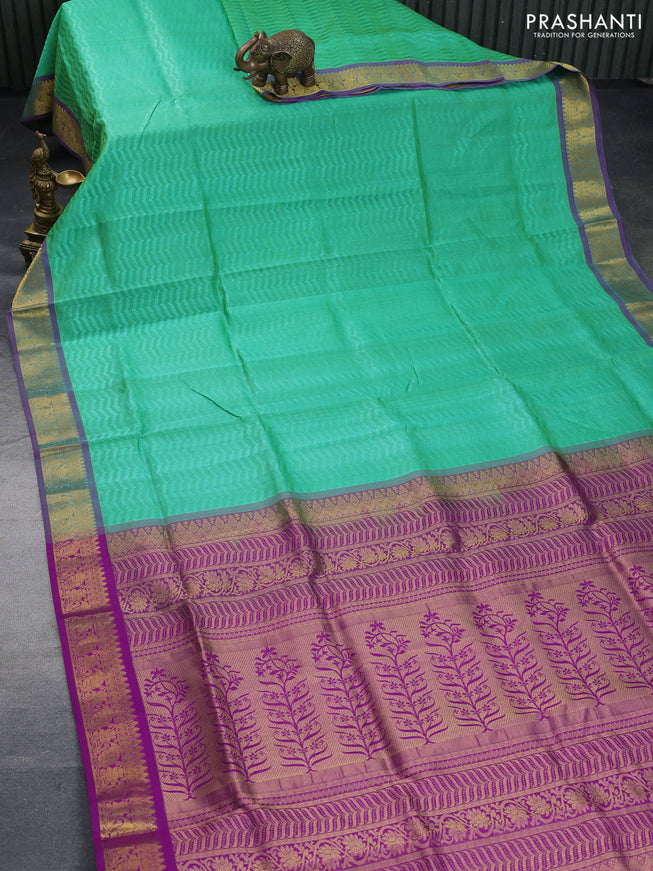 Silk cotton saree green and purple with allover self emboss & jacquard and zari woven border