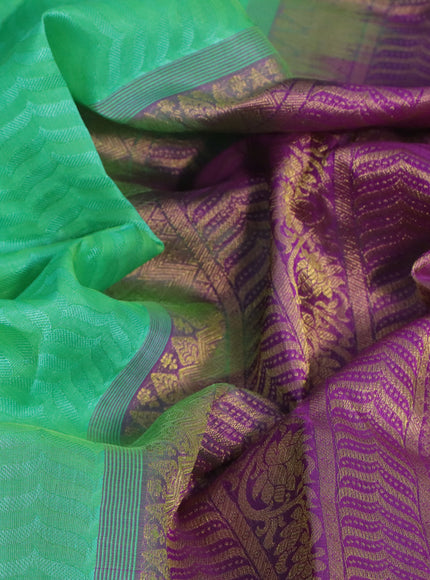 Silk cotton saree green and purple with allover self emboss & jacquard and zari woven border