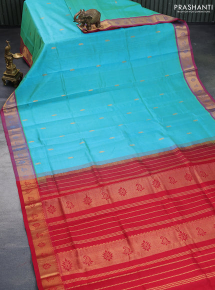 Silk cotton saree dual shade of teal bluish green and kumkum red with paisley zari woven buttas and rich zari woven border