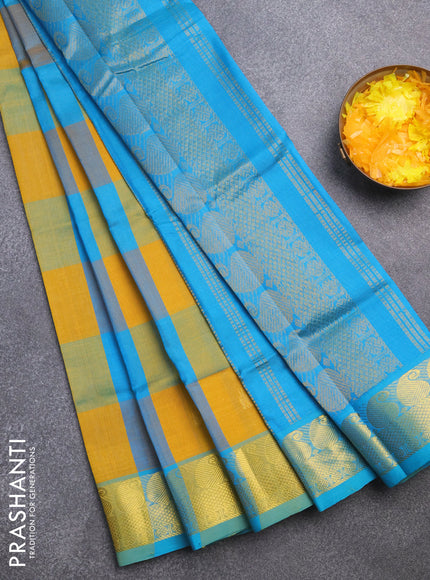 Silk cotton saree mustard yellow and teal blue shade with allover paalum pazhamum checks & zari buttas and paisley zari woven border