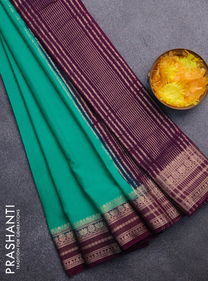 Semi crepe saree teal green and purple with plain body and zari woven border