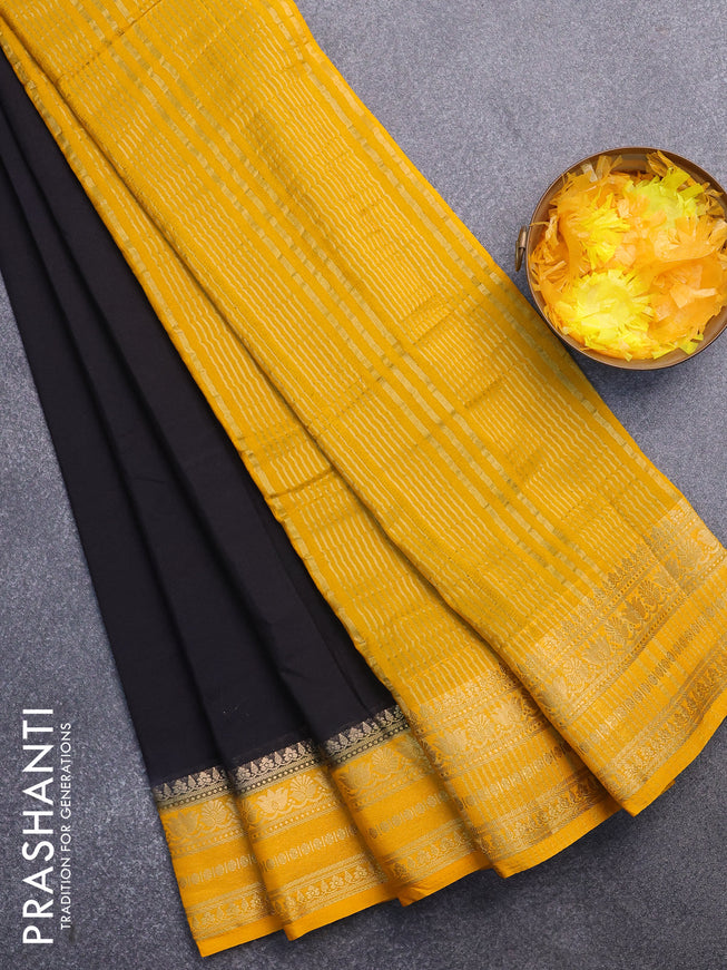 Semi crepe saree black and mango yellow with plain body and zari woven border