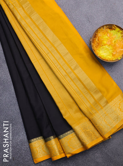 Semi crepe saree black and mango yellow with plain body and zari woven border