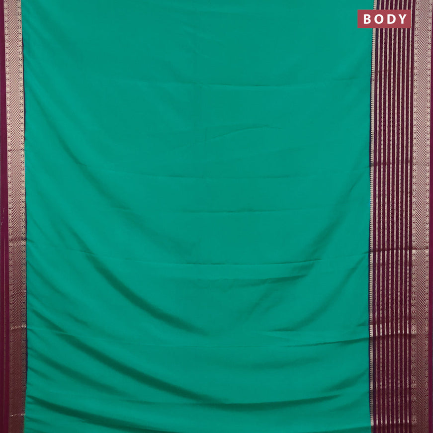 Semi crepe saree teal green and purple with plain body and long zari woven border