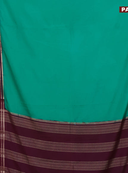 Semi crepe saree teal green and purple with plain body and long zari woven border