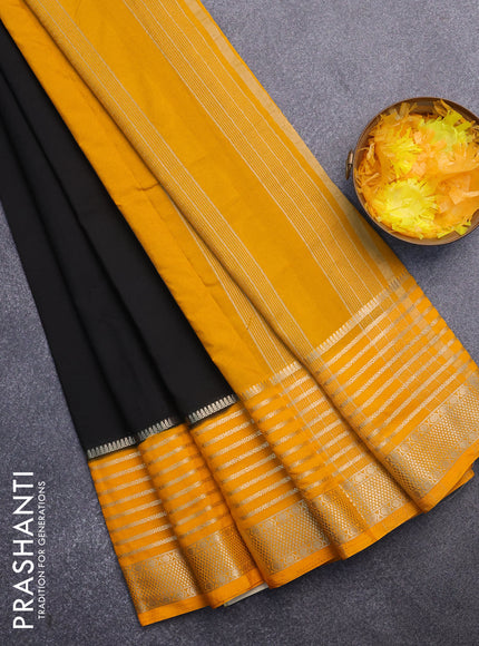 Semi crepe saree black and mango yellow with plain body and long zari woven border