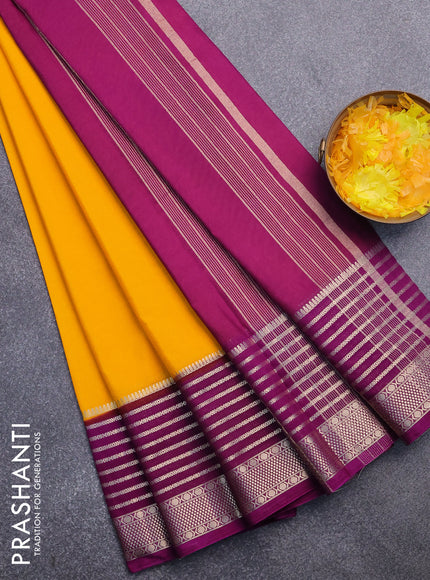 Semi crepe saree mango yellow and purple with plain body and long zari woven border