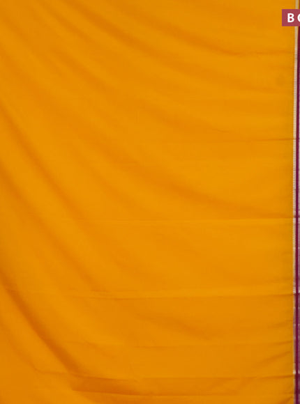 Semi crepe saree mango yellow and purple with plain body and long zari woven border