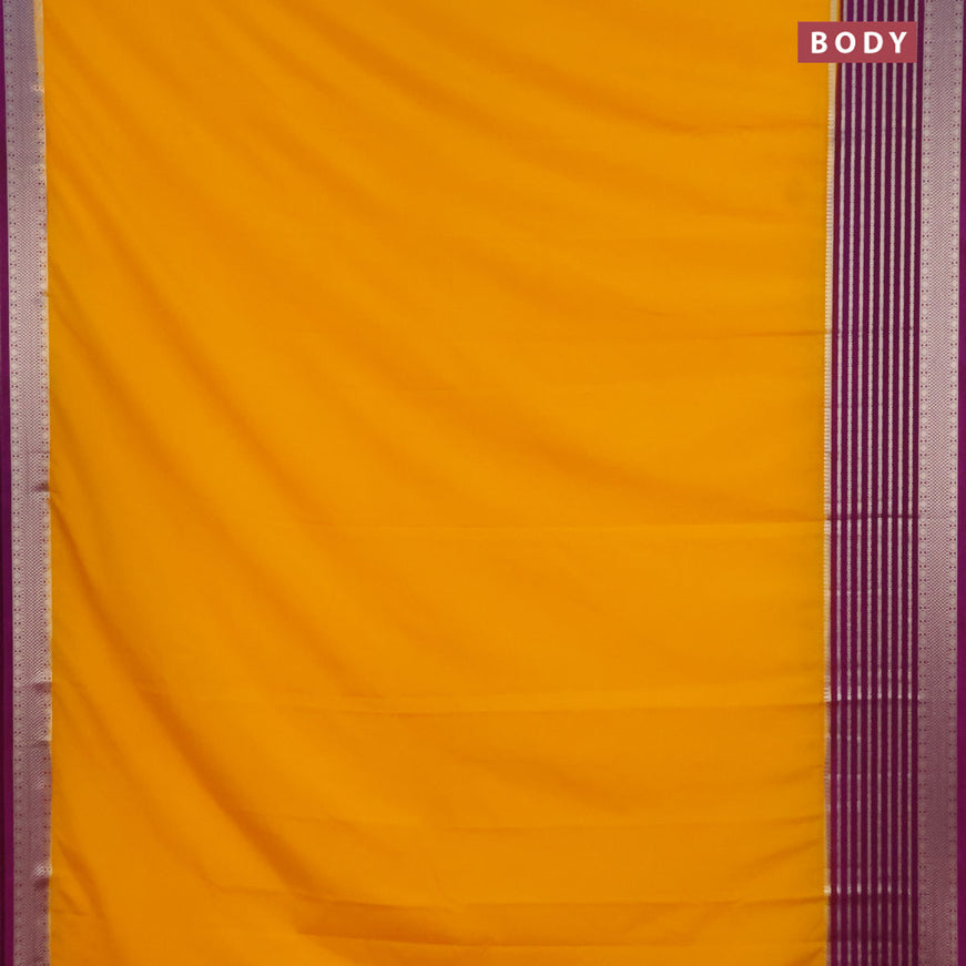 Semi crepe saree mango yellow and purple with plain body and long zari woven border