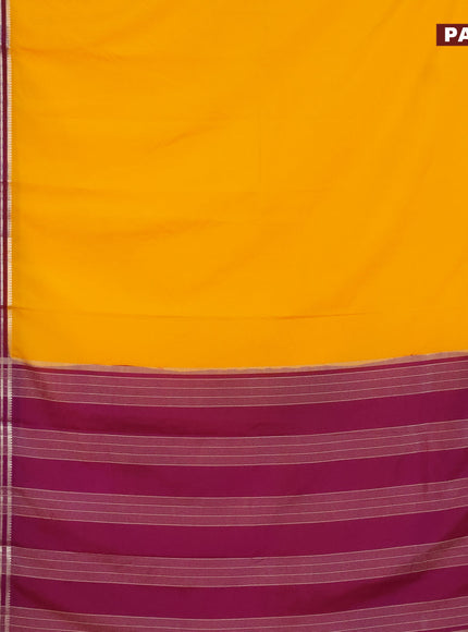 Semi crepe saree mango yellow and purple with plain body and long zari woven border