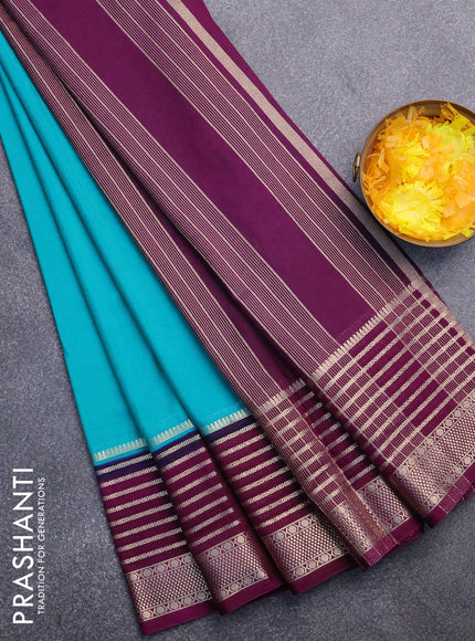 Semi crepe saree teal green shade and purple with plain body and long zari woven border