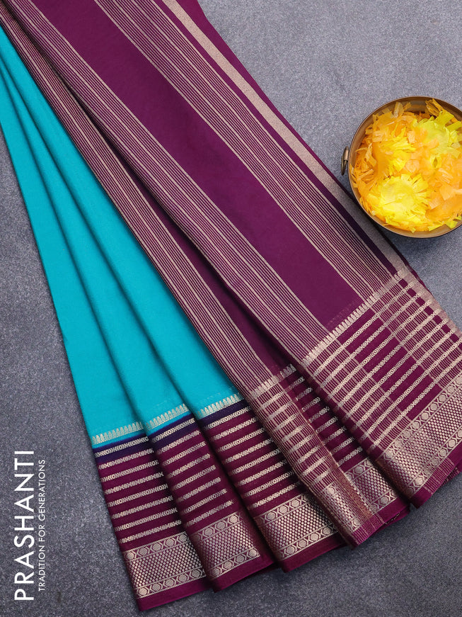 Semi crepe saree teal green shade and purple with plain body and long zari woven border