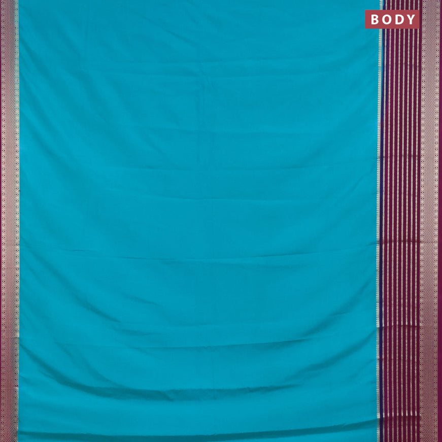 Semi crepe saree teal green shade and purple with plain body and long zari woven border