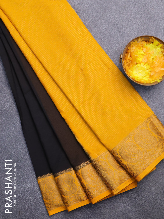 Semi crepe saree black and mango yellow with plain body and paisley zari woven border