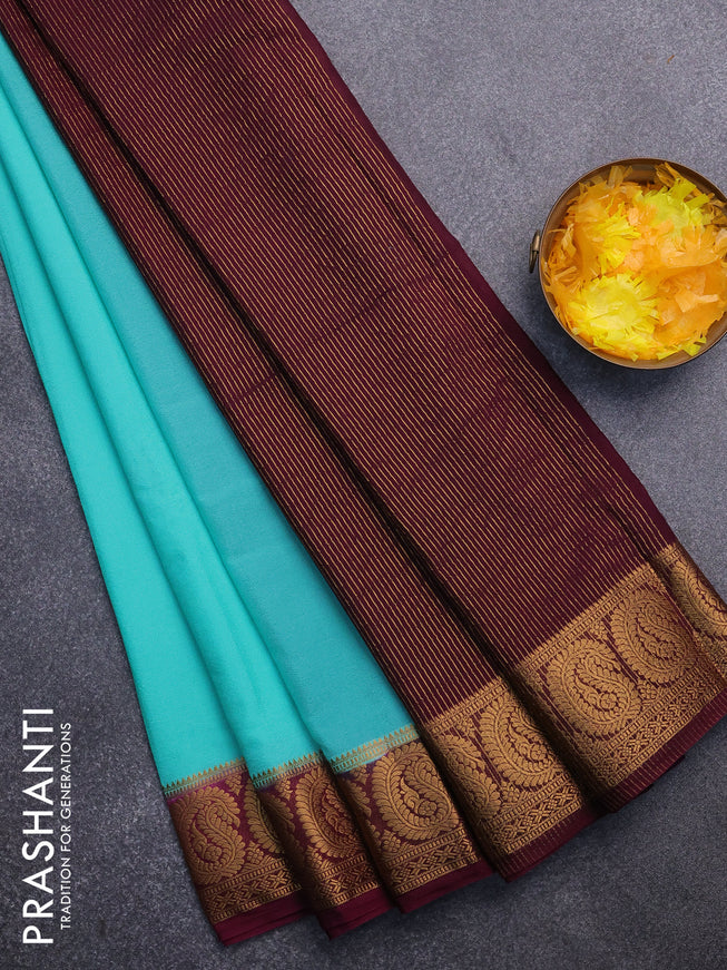 Semi crepe saree teal blue and wine shade with plain body and paisley zari woven border