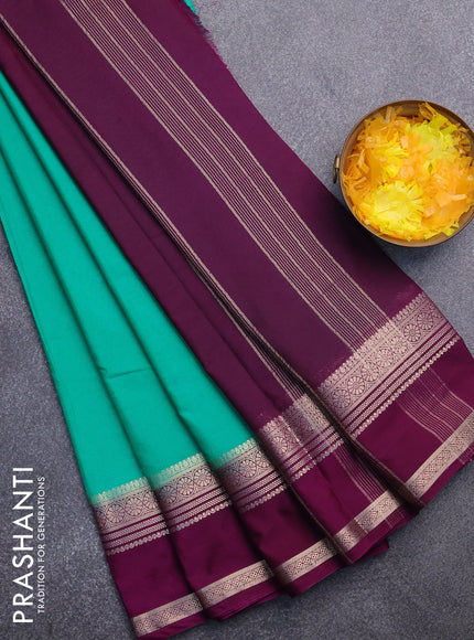 Semi crepe saree teal green shade and purple with plain body and rettapet zari woven border