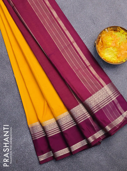 Semi crepe saree mango yellow and purple with plain body and rettapet zari woven border