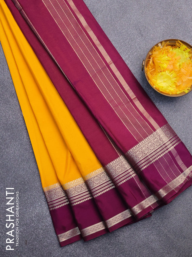 Semi crepe saree mango yellow and purple with plain body and rettapet zari woven border