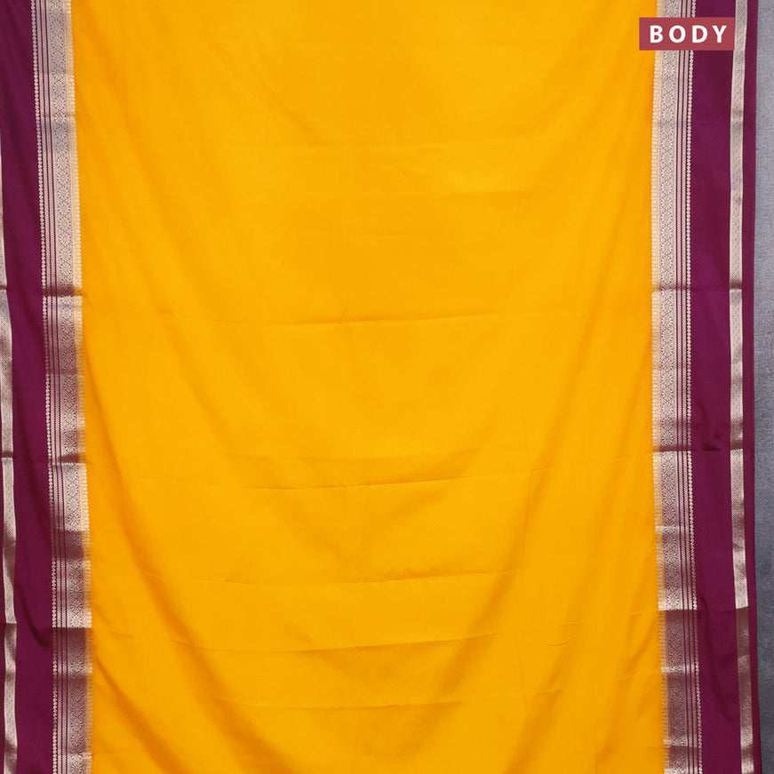 Semi crepe saree mango yellow and purple with plain body and rettapet zari woven border