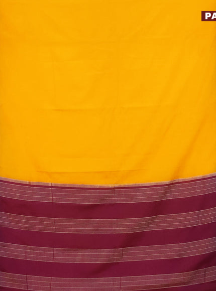 Semi crepe saree mango yellow and purple with plain body and rettapet zari woven border